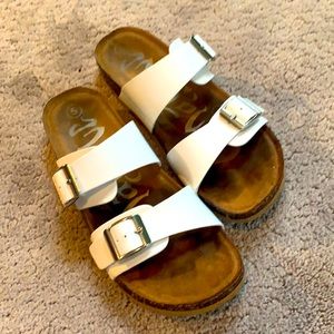 White target sandals with silver buckles.